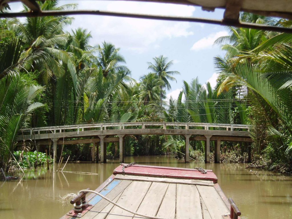 A Mekong Delta woman in a conical hat during a guided village cycling stop