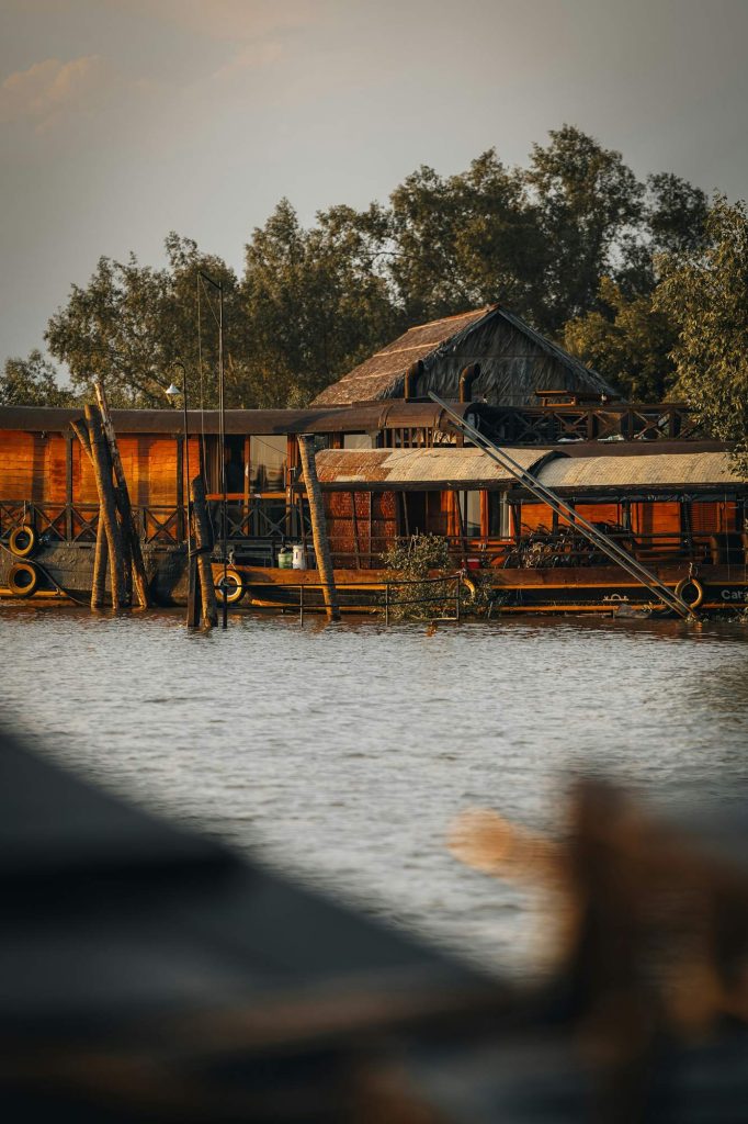 A wooden stilt house floating quietly in the Mekong Delta floodplain