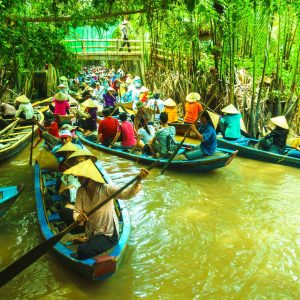 Wooden boats loaded with produce at a Ben Tre canal-side market — the classic delta water scene