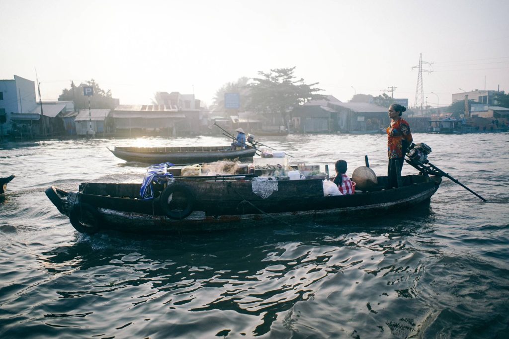 a trading boat (ghe thương hồ) loaded with goods — Cai Rang Floating Market at Dawn, mekongtodo real Mekong Delta tour