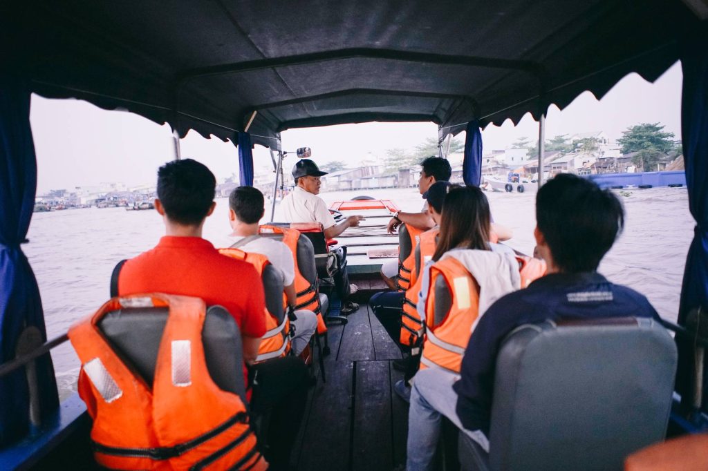 travellers together on a wooden boat at sunrise — Cần Thơ Authentic Day, mekongtodo real Mekong Delta tour
