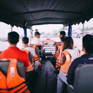travellers together on a wooden boat at sunrise — Cần Thơ Authentic Day, mekongtodo real Mekong Delta tour